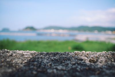 Surface level of rocks on field against sky