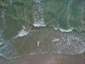 High angle view of man surfing in sea