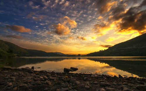 Scenic view of lake against orange sky