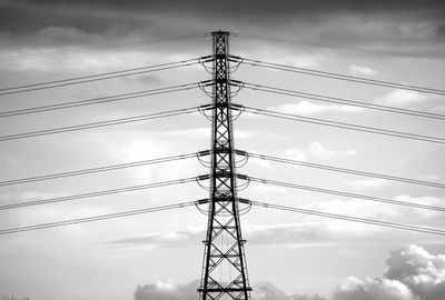 Low angle view of electricity pylon against sky