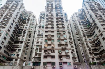 Low angle view of buildings in city against sky