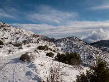Scenic view of snow covered mountains against sky