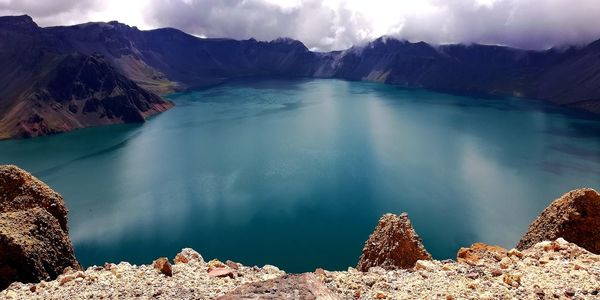 Panoramic view of lake against cloudy sky