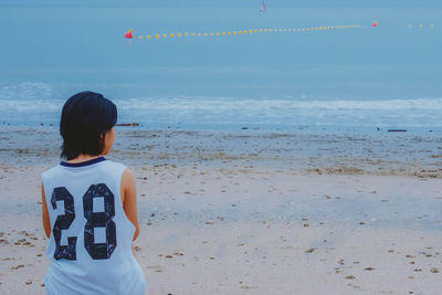 Rear view of woman at beach