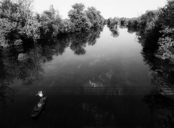 High angle view of trees by lake against sky