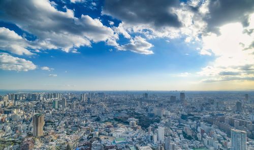 High angle view of city against cloudy sky