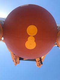 Low angle view of hot air balloon against blue sky