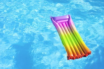 High angle view of multi colored pencils on swimming pool