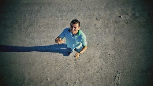 High angle portrait of man standing on road