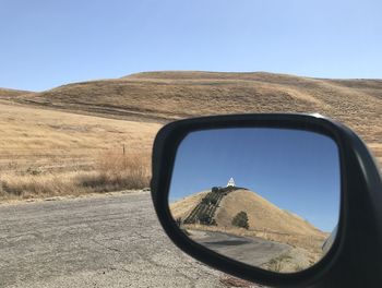 Reflection of road on side-view mirror