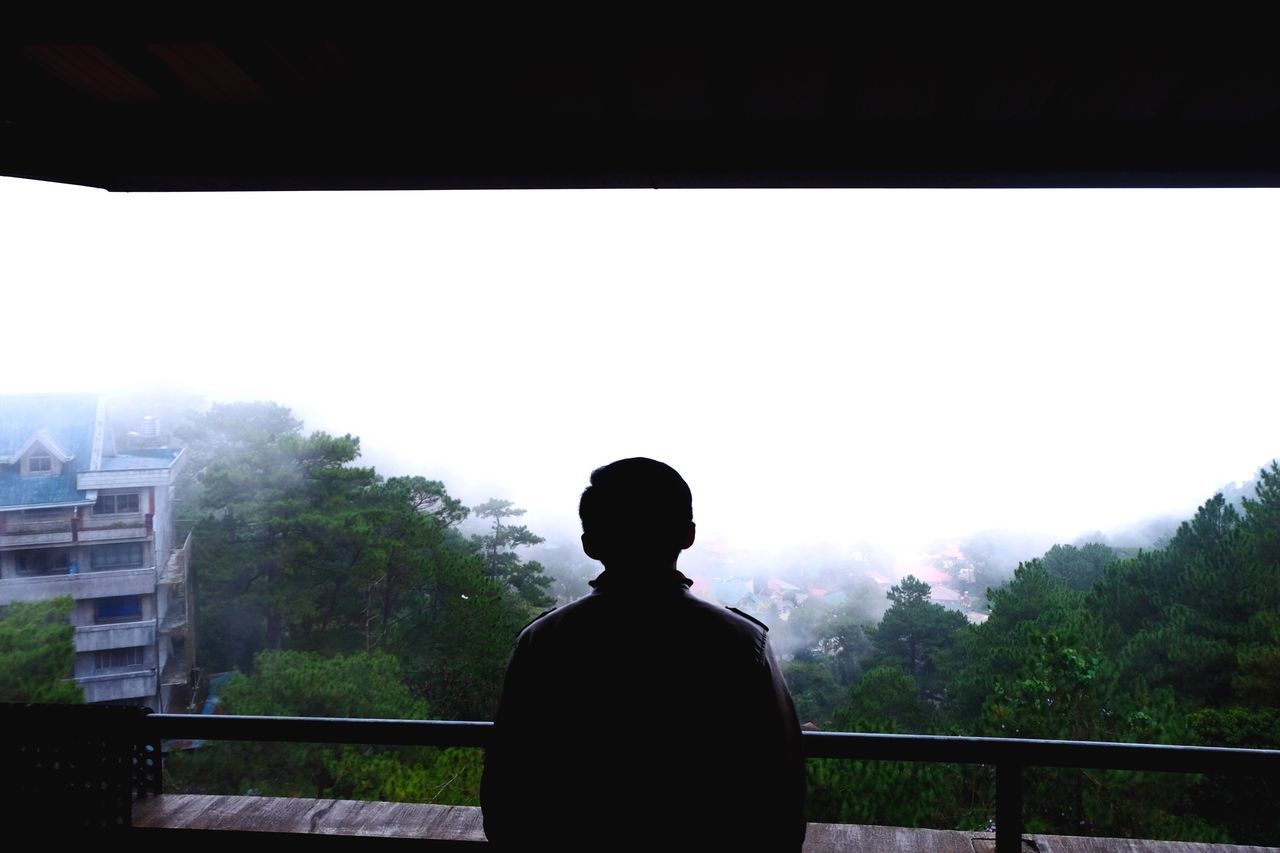 SILHOUETTE OF MAN AGAINST CLEAR SKY