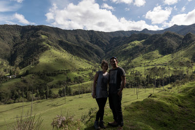 Portrait of couple standing at cocora valley against sky