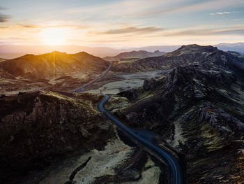 Mountainous area and highway at sunset