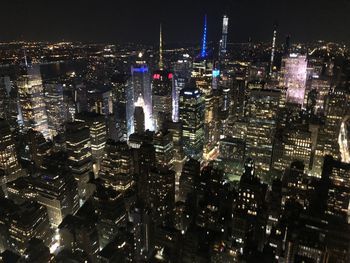 High angle view of city lit up at night