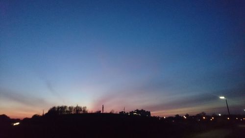 Silhouette of landscape against sky at dusk