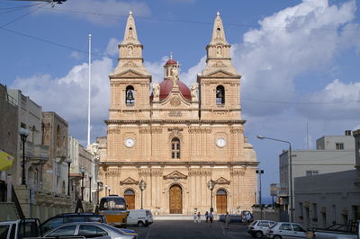 Low angle view of church against cloudy sky