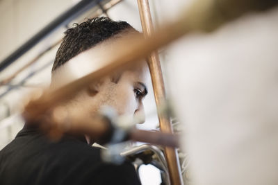 Selective focus of thoughtful auto mechanic student in workshop