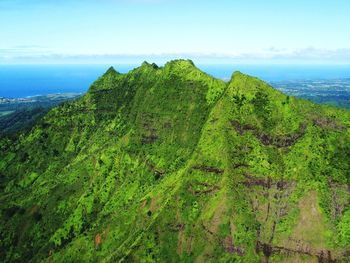 Scenic view of sea and mountains against sky