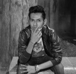 Portrait of young man smoking outdoors