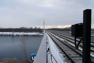 Train on railroad tracks against sky during winter