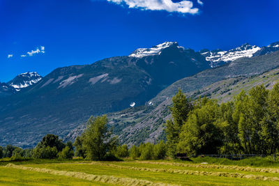 Scenic view of mountains against blue sky