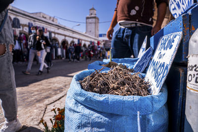 Closeup of dry roots in sack at market for sale on street on sunny day