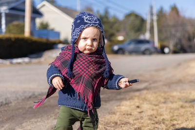 Portrait of cute girl standing on field