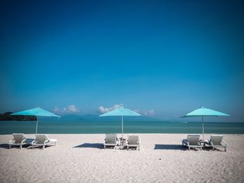 Scenic view of beach against blue sky