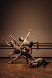 Image of a group of modern little ballerinas standing in a modern dance pose. copy space