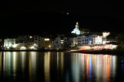 Illuminated city against sky at night