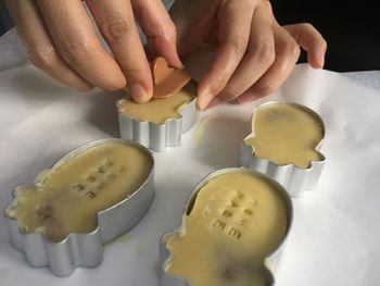 Close-up of woman preparing food on table 