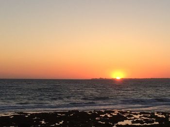 Scenic view of sea against clear sky during sunset