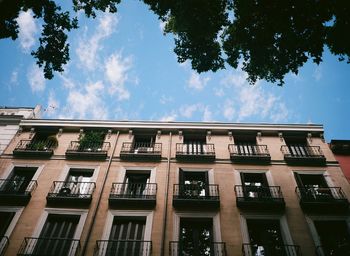 Low angle view of building against cloudy sky