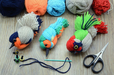 High angle view of woolen colorful crafts on table