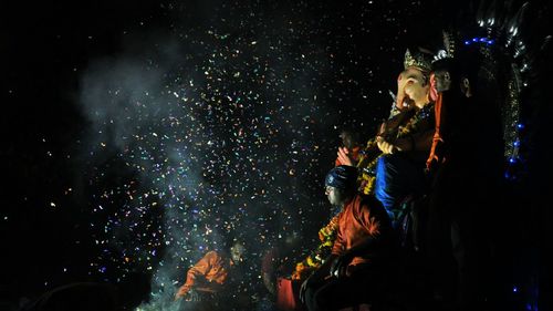 People watching firework display at night