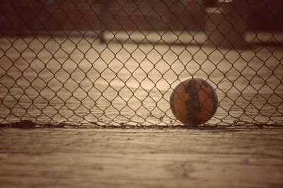 Ball behind chainlink fence