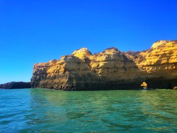 Scenic view of sea against clear blue sky