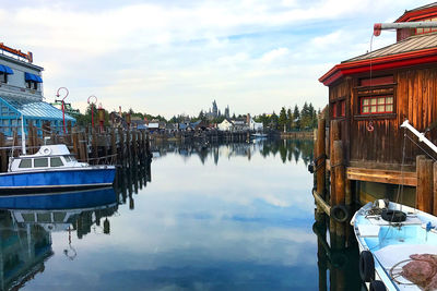 Panoramic view of canal and houses against sky