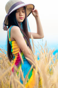 Young woman wearing hat on field