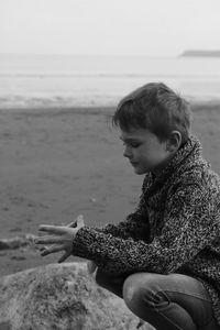 Boy sitting at beach