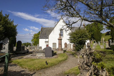 Panoramic view of cemetery and buildings against sky