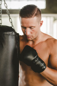 Shirtless boxer practicing boxing