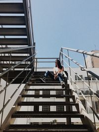 Low angle view of man against buildings against clear sky