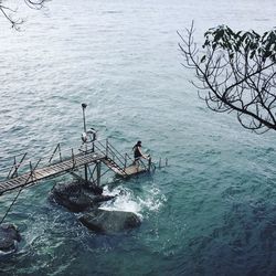 High angle view of man sitting in sea