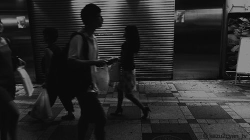 Group of people standing in the dark