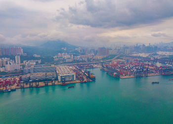 High angle view of buildings by sea against sky