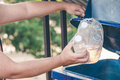Midsection of man holding drink in water