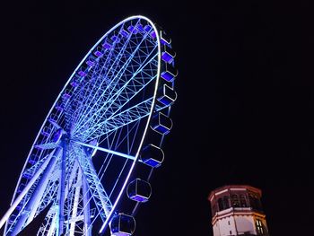 Low angle view of ferris wheel against sky