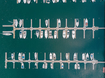 Aerial view of boats moored at harbor on sea