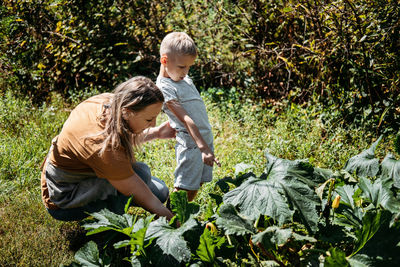 Green thumbs, spring is here, home gardens and picking vegetables. happy family, mom and kid